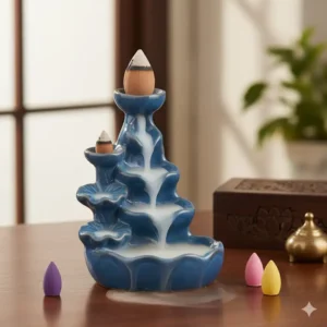 Elegant blue ceramic backflow incense burner with smoke cascading down a waterfall design.