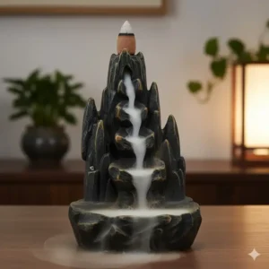 A decorative tall incense burner designed for backflow cones with smoke cascading down mountain peaks.