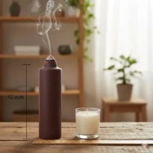 A 12-inch tall incense burner placed next to a standard candle to demonstrate its height and scale.