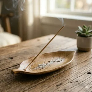 A long leaf-shaped ceramic incense burner holder safely catching falling ash.